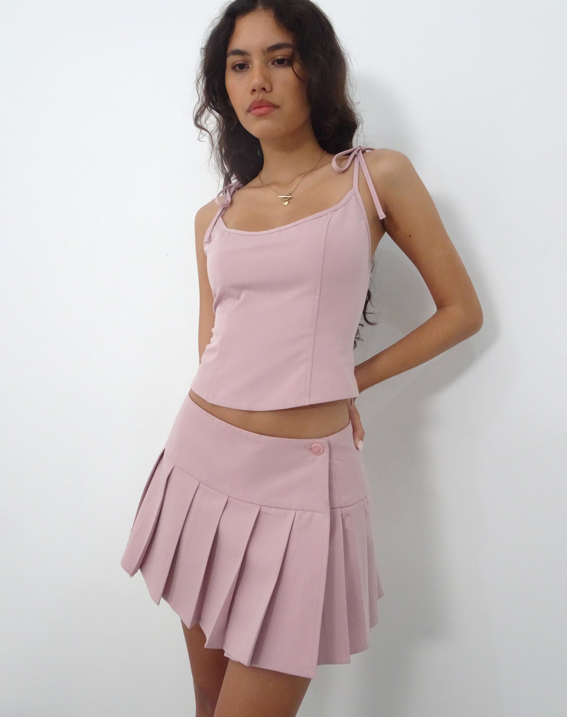 Pink pleated uniform skirt hotsell